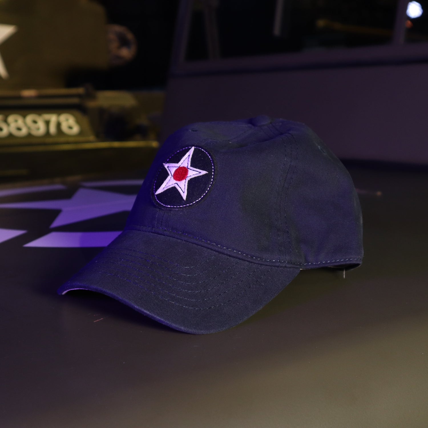 Blue cap with a star emblem on a military vehicle at night